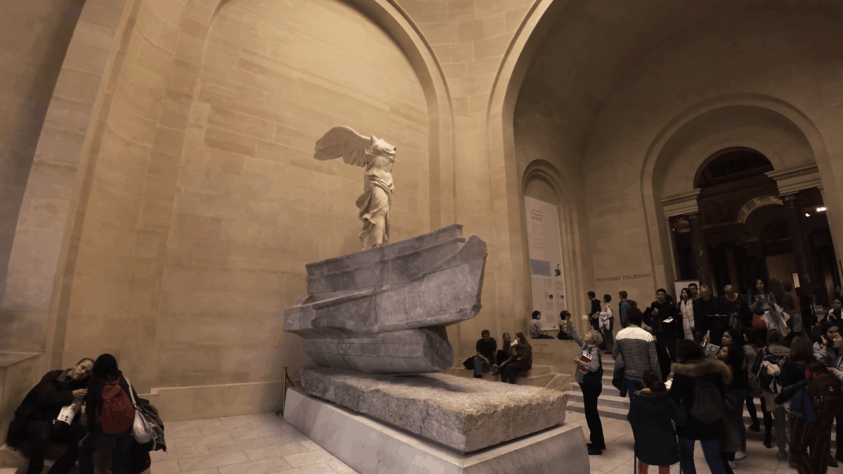 The Winged Victory of Samothrace, also called the Nike of Samothrace in the Louvre museum in Paris. Visitors surround the statue. 